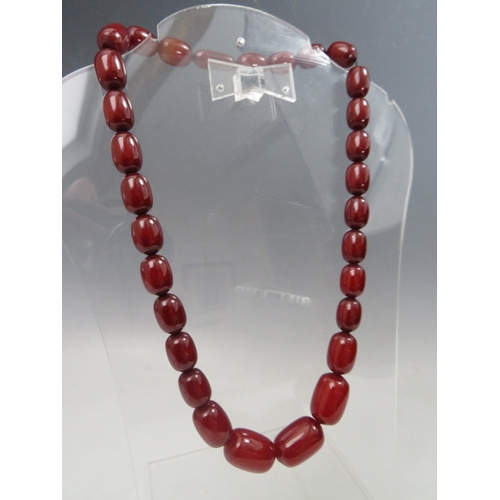 274 - A VINTAGE CHERRY AMBER GRADUATED BEAD NECKLACE, single strand with screw barrel fastening, central b... 