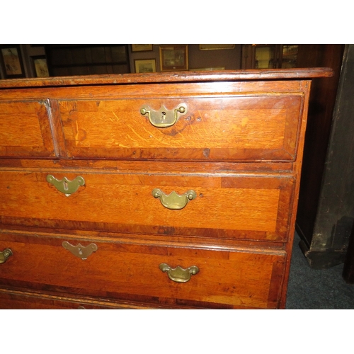 572 - A 19TH CENTURY OAK CROSSBANDED CHEST OF SMALL PROPORTIONS, with two short above three longer graduat... 