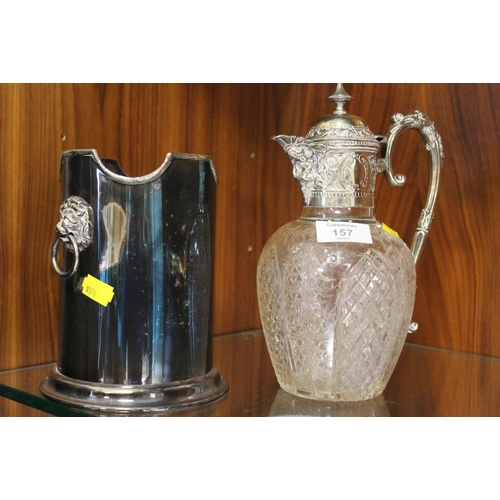 157 - AN ANTIQUE SILVER PLATED CUT GLASS CLARET JUG TOGETHER WITH A LION MASK BOTTLE HOLDER (2)