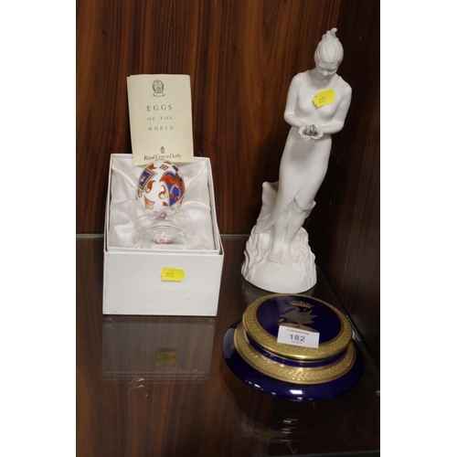 182 - A BOXED ROYAL CROWN DERBY CERAMIC EGG WITH STAND, TOGETHER WITH A ROYAL DOULTON FIGURINE ETC (3)