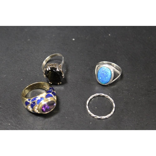 276 - FOUR ASSORTED DRESS RINGS COMPRISING THREE SILVER EXAMPLES TOGETHER WITH A JOAN RIVERS GILT METAL EN... 