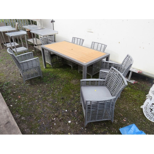 663 - A MODERN RECTANGULAR PATIO TABLE AND SIX CHAIRS