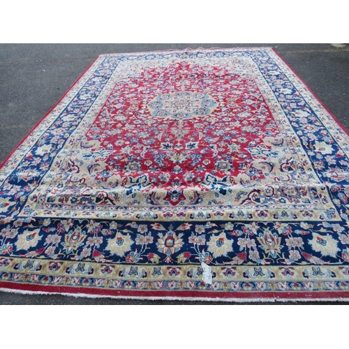 883 - A LARGE RUG, CREAM GROUND WITH RED AND BLUE, APPROX 368 X 270 - WEAR THROUGHOUT