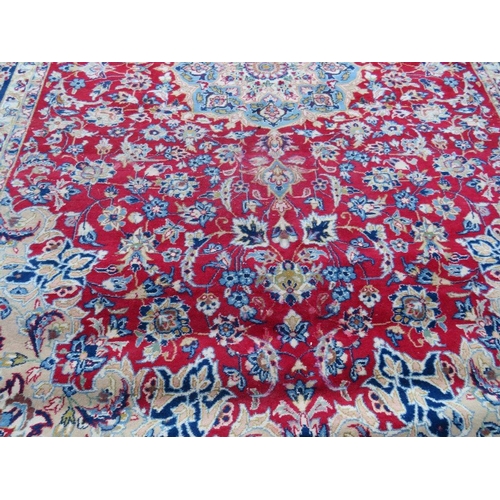 883 - A LARGE RUG, CREAM GROUND WITH RED AND BLUE, APPROX 368 X 270 - WEAR THROUGHOUT