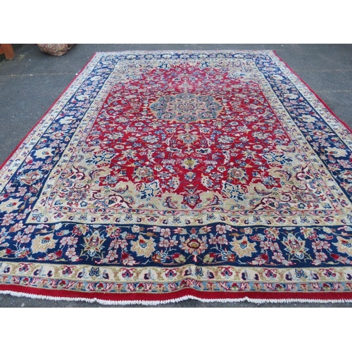 883 - A LARGE RUG, CREAM GROUND WITH RED AND BLUE, APPROX 368 X 270 - WEAR THROUGHOUT