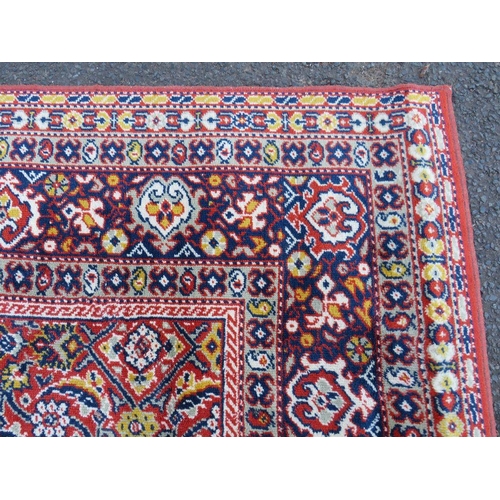 884 - A LARGE CARPET - RUST / TERRACOTTA GROUND WITH NAVY / YELLOW PATTERN, APPROX 365 X 253 CM - WEAR THR... 