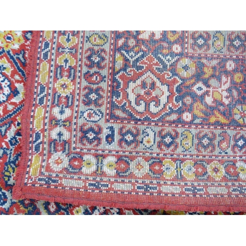 884 - A LARGE CARPET - RUST / TERRACOTTA GROUND WITH NAVY / YELLOW PATTERN, APPROX 365 X 253 CM - WEAR THR... 