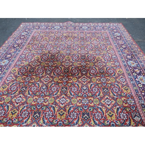 884 - A LARGE CARPET - RUST / TERRACOTTA GROUND WITH NAVY / YELLOW PATTERN, APPROX 365 X 253 CM - WEAR THR... 