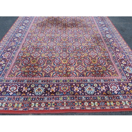 884 - A LARGE CARPET - RUST / TERRACOTTA GROUND WITH NAVY / YELLOW PATTERN, APPROX 365 X 253 CM - WEAR THR... 