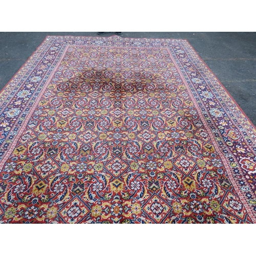 884 - A LARGE CARPET - RUST / TERRACOTTA GROUND WITH NAVY / YELLOW PATTERN, APPROX 365 X 253 CM - WEAR THR... 