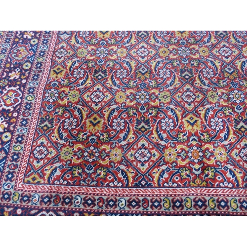 884 - A LARGE CARPET - RUST / TERRACOTTA GROUND WITH NAVY / YELLOW PATTERN, APPROX 365 X 253 CM - WEAR THR... 