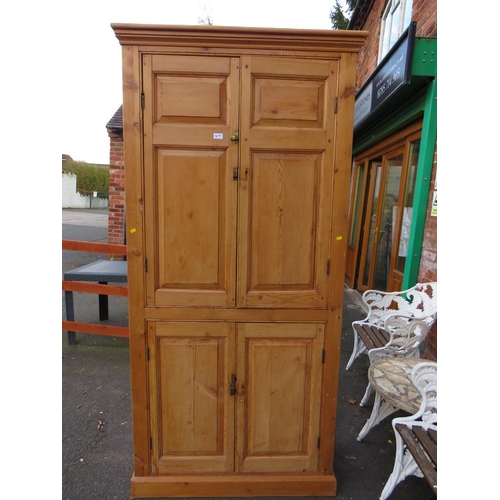 877 - AN ANTIQUE PINE LARGE FOUR DOOR CUPBOARD H-212 W-102 CM