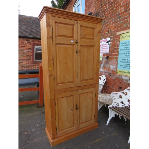 877 - AN ANTIQUE PINE LARGE FOUR DOOR CUPBOARD H-212 W-102 CM