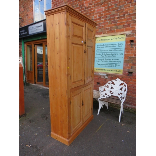 877 - AN ANTIQUE PINE LARGE FOUR DOOR CUPBOARD H-212 W-102 CM