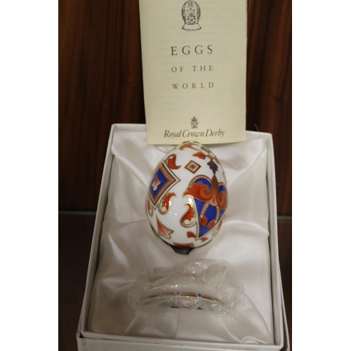 182 - A BOXED ROYAL CROWN DERBY CERAMIC EGG WITH STAND, TOGETHER WITH A ROYAL DOULTON FIGURINE ETC (3)