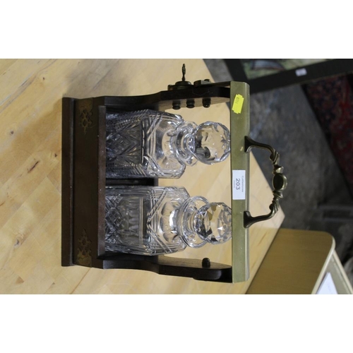 203 - A TWO BOTTLE TANTALUS WITH MATCHED GLASS DECANTERS