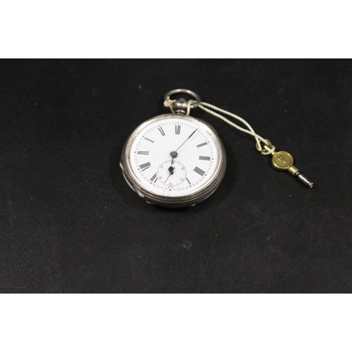 240 - AN ANTIQUE SILVER CASED POCKET WATCH WITH KEY