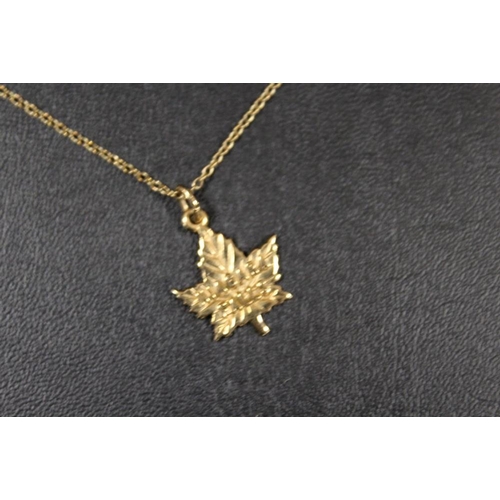 307 - A 10K REMBRANT NIAGRA FALLS MAPLE LEAF PENDANT ON CHAIN STAMPED 9K - APPROX COMBINED WEIGHT 2.6 G