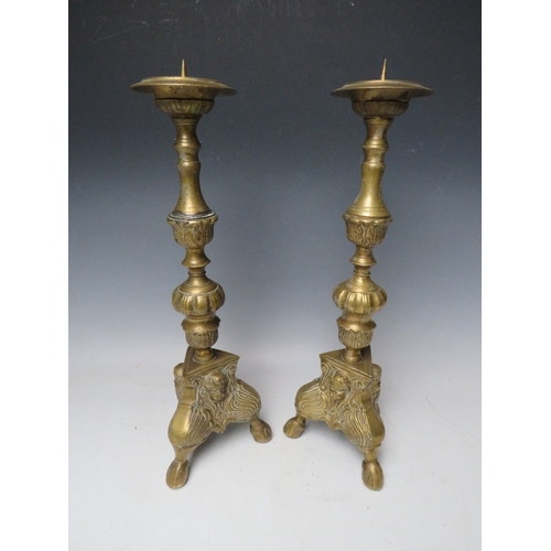 183 - A PAIR OF DECORATIVE BRASS PRICKET CANDLESTICKS, with cherubic mask detail, H 43 cm (2)