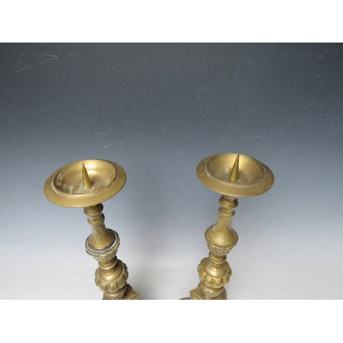 183 - A PAIR OF DECORATIVE BRASS PRICKET CANDLESTICKS, with cherubic mask detail, H 43 cm (2)