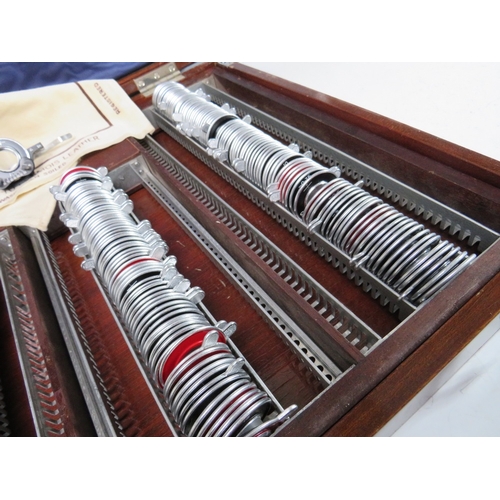 215 - A LARGE OPTICIANS TRIAL LENS SET WITH CLEMENT CLARKE HOLDER, in mahogany case