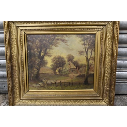 29 - A GILT FRAMED OIL ON BOARD OF A SHEPHERD AND SHEEP BEFORE A THATCHED COTTAGE