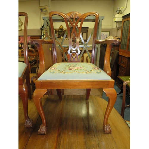 812 - A LARGE EARLY 20TH CENTURY MAHOGANY SIDEBOARD, WIND-OUT DINING TABLE AND 7 CHAIRS ON BALL AND CLAW F... 