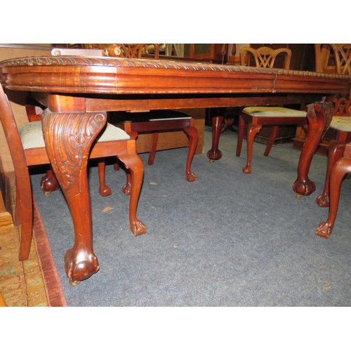 812 - A LARGE EARLY 20TH CENTURY MAHOGANY SIDEBOARD, WIND-OUT DINING TABLE AND 7 CHAIRS ON BALL AND CLAW F... 