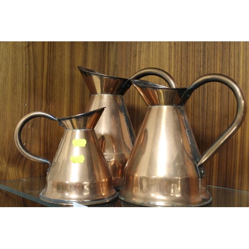 193 - A SET OF THREE GRADUATED COPPER JUGS