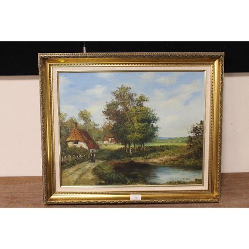 10 - A GILT FRAMED OIL ON CANVAS OF A VILLAGE POND WITH THATCHED COTTAGE