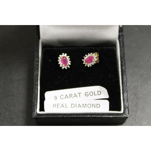 229 - A PAIR OF A RUBY AND DIAMOND SET EARRINGS