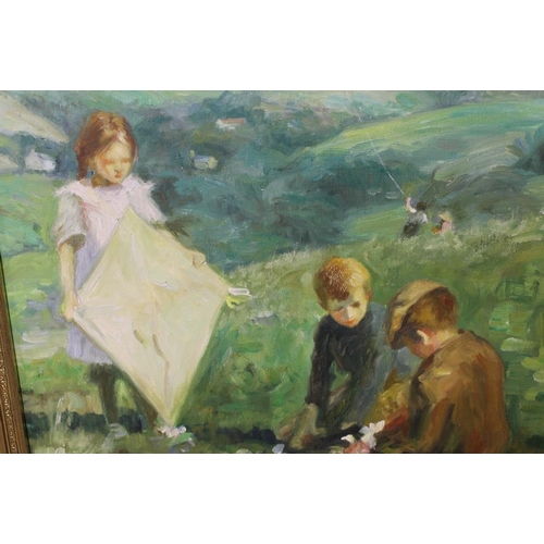 24 - A GILT FRAMED OIL ON CANVAS OF CHILDREN PLAYING WITH KITES ON A HILLSIDE