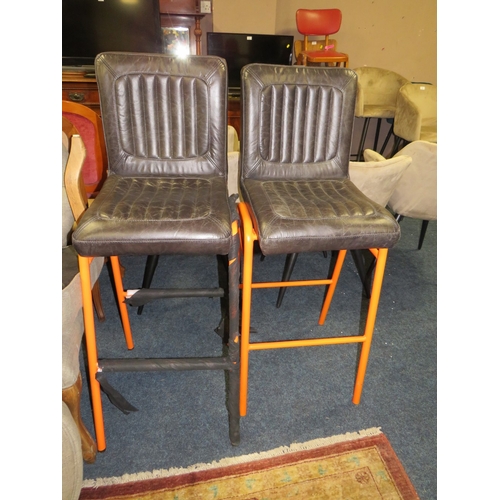 769 - A PAIR OF LEATHER STOOLS WITH ORANGE LEGS