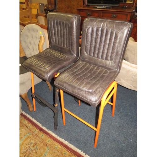 769 - A PAIR OF LEATHER STOOLS WITH ORANGE LEGS