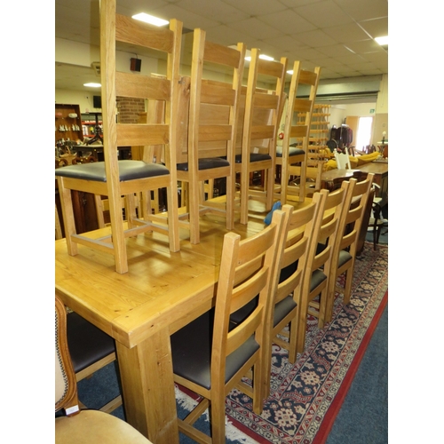 773 - A LARGE EXTENDING OAK DINING TABLE WITH FOURTEEN CHAIRS W-230 CM EXTENDING TO W-320 CM