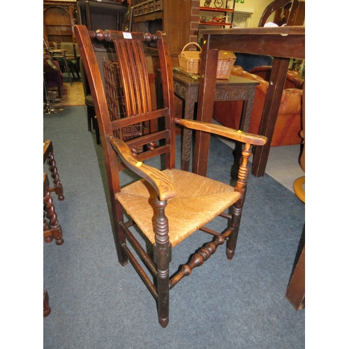 803 - AN ANTIQUE OAK WICKER SEAT ARMCHAIR