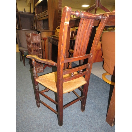 803 - AN ANTIQUE OAK WICKER SEAT ARMCHAIR