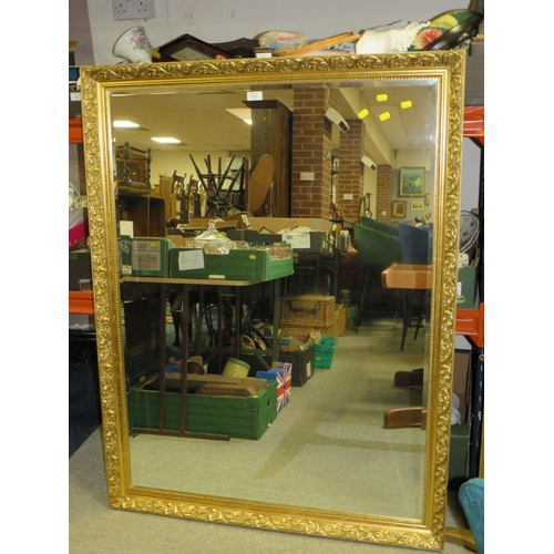 810 - A LARGE MODERN GILT FRAMED MIRROR 130 X 100 CM