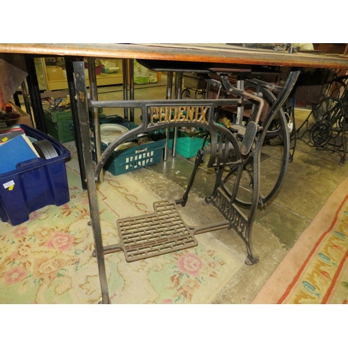 817 - AN ANTIQUE PHOENIX SEWING MACHINE AND TREADLE TABLE