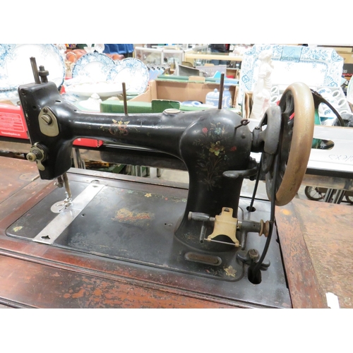 818 - AN ANTIQUE FEDERATION SEWING MACHINE AND TREADLE TABLE