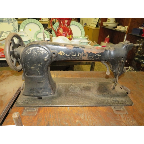 819 - AN ANTIQUE JONES SEWING MACHINE AND TREADLE TABLE