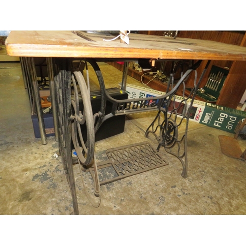 819 - AN ANTIQUE JONES SEWING MACHINE AND TREADLE TABLE