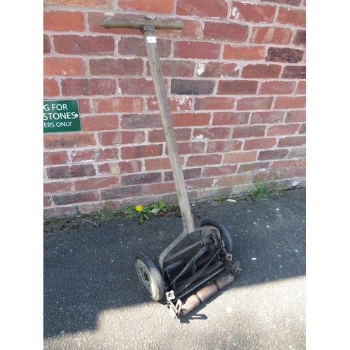 611 - AN ANTIQUE PUSH MOWER