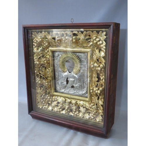 28 - A LATE 18TH / EARLY 19TH CENTURY BOXED AND GLAZED DECORATIVE GOLD FRAME, containing a faded Icon wit... 