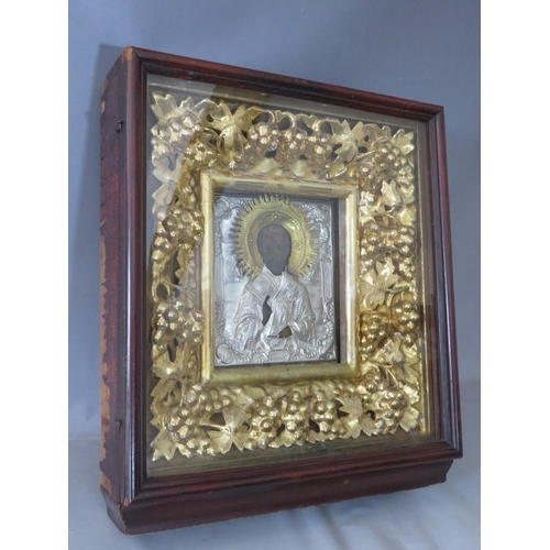 28 - A LATE 18TH / EARLY 19TH CENTURY BOXED AND GLAZED DECORATIVE GOLD FRAME, containing a faded Icon wit... 