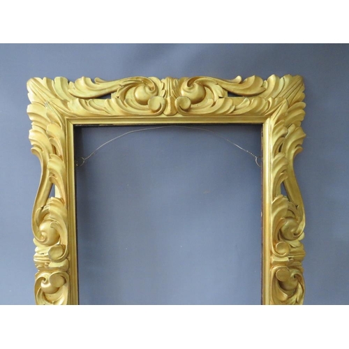 50 - A LATE 18TH / EARLY 19TH CENTURY CARVED WOODEN DECORATIVE GOLD FRAME, frame W 12 cm, rebate 65 x 47 ... 