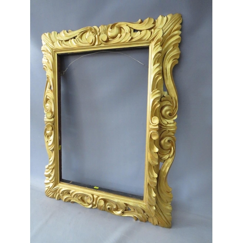 50 - A LATE 18TH / EARLY 19TH CENTURY CARVED WOODEN DECORATIVE GOLD FRAME, frame W 12 cm, rebate 65 x 47 ... 