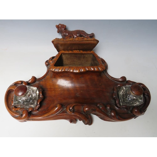 503 - A LATE 19TH / EARLY 20TH CENTURY MAHOGANY DESK TIDY, with pair of inkwells and carved wooden lid in ... 