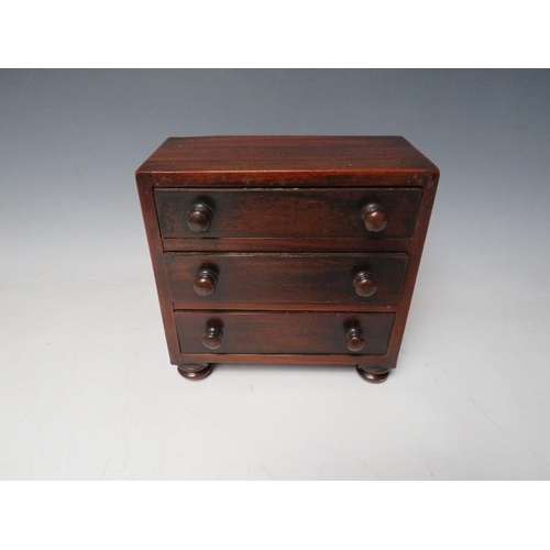 507 - A 19TH CENTURY MINIATURE MAHOGANY THREE DRAWER CHEST, raised on four turned feet, H 17 cm W 18 cm