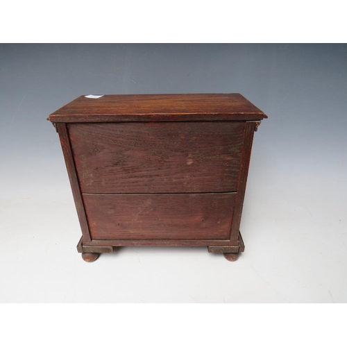 511 - A VICTORIAN MINIATURE OAK COLLECTORS CHEST OF EIGHT DRAWERS, with beadwork detail, raised on bun fee... 